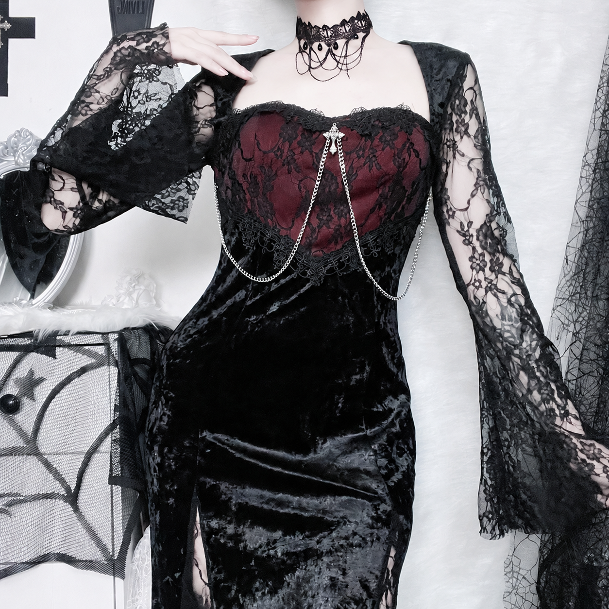 Burgundy lace bodice, square neckline, silver-tone chains and flared lace sleeve detail of the black velvet dress