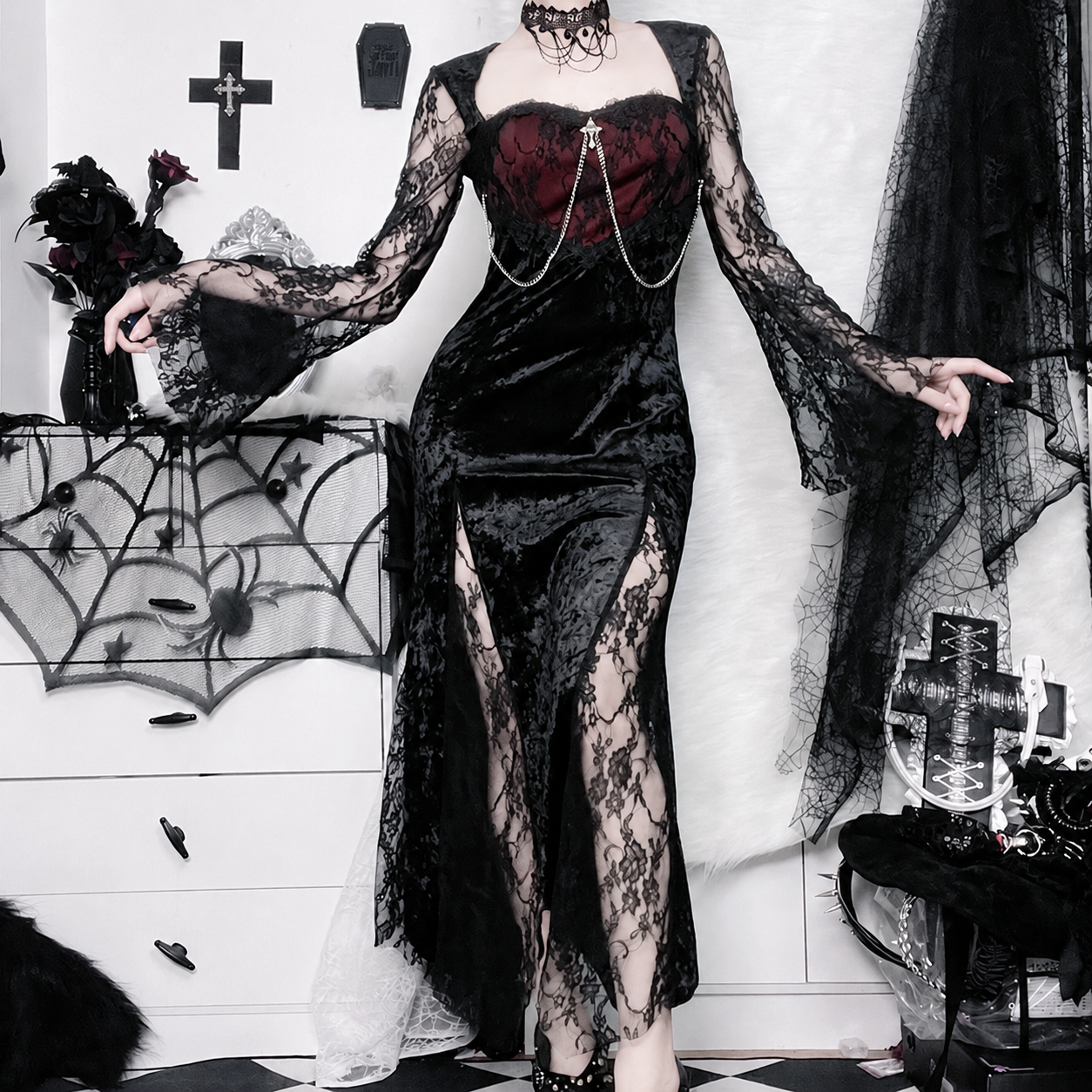 Front view of an adult model wearing a black velvet dress with burgundy bodice, lace sleeves and skirt slits